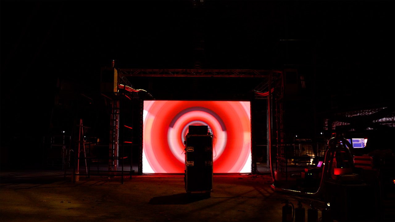 Cartier Santos installation, scaffolded screen structure in a dark hall