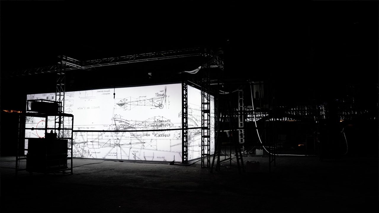 Cartier Santos installation, scaffolded screen structure in a dark hall — image 02