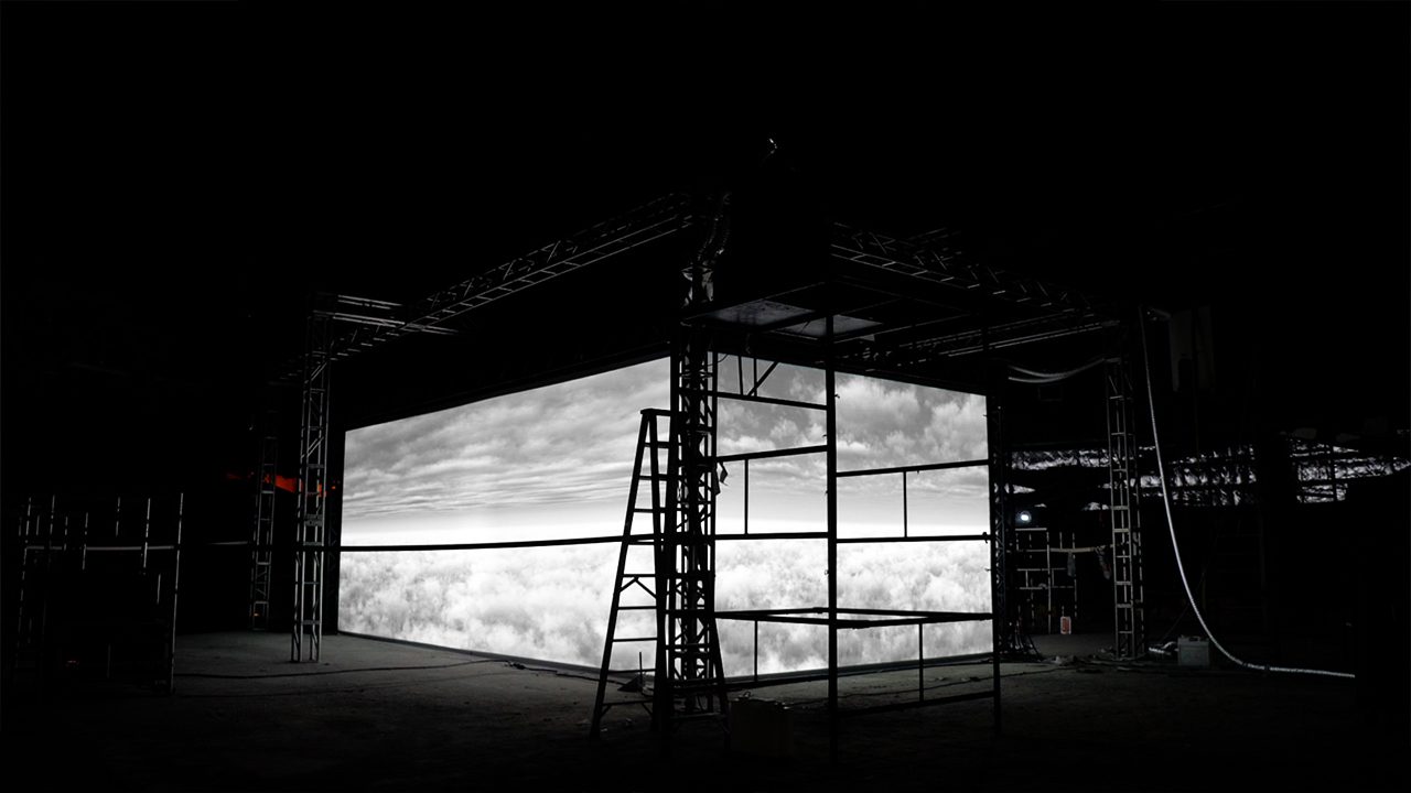 Cartier Santos installation, scaffolded screen structure in a dark hall — image 03