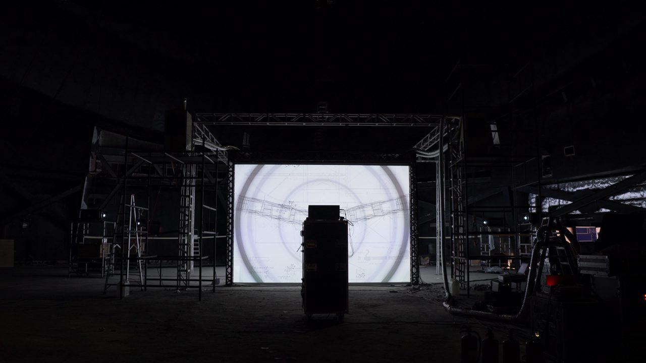 Cartier Santos installation, scaffolded screen structure in a dark hall — image 04