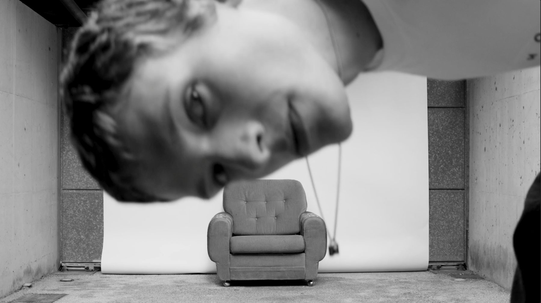 Hogan campaign film, a single armchair against a white backdrop