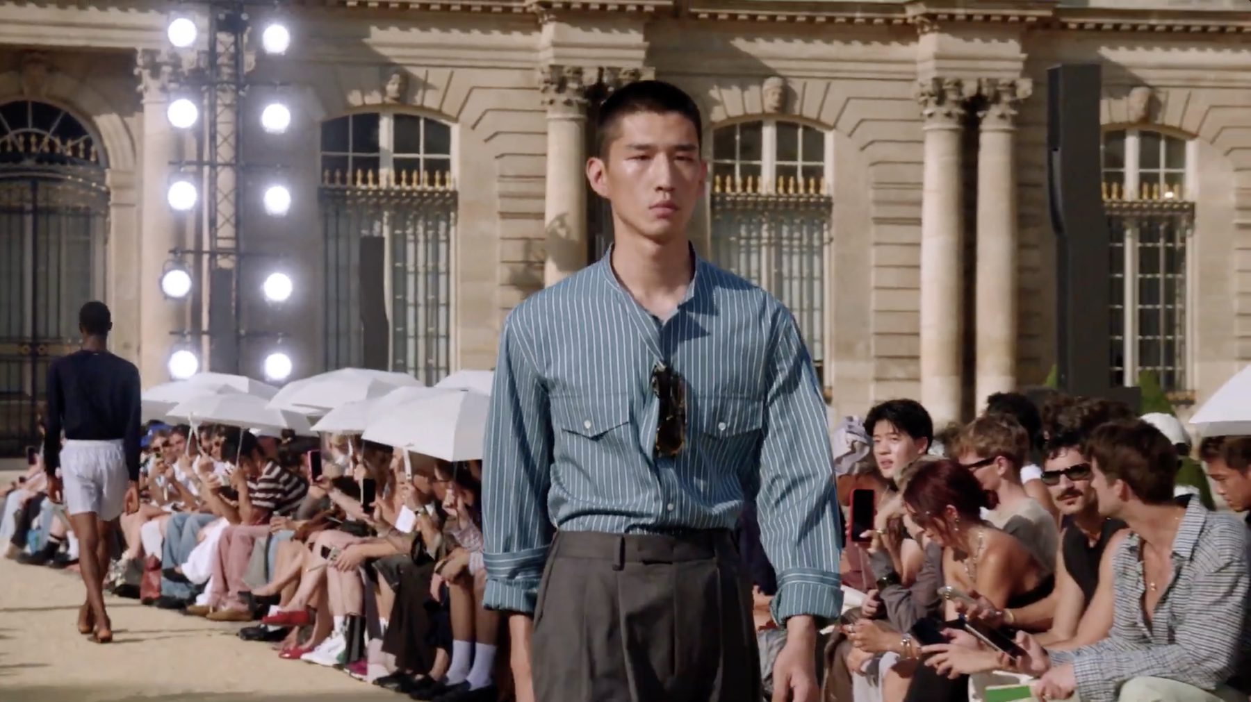System Spring/Summer 2027 show, white parasols along a sand runway — image 03
