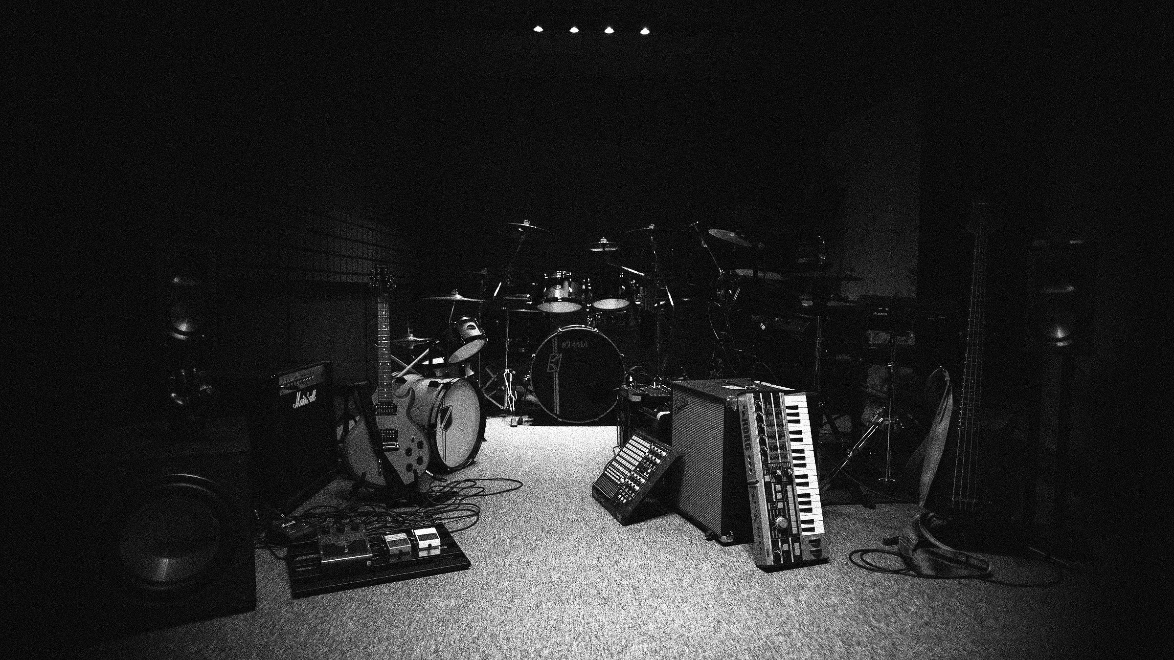 The live room: drum kit, amplifiers and synthesisers under low light