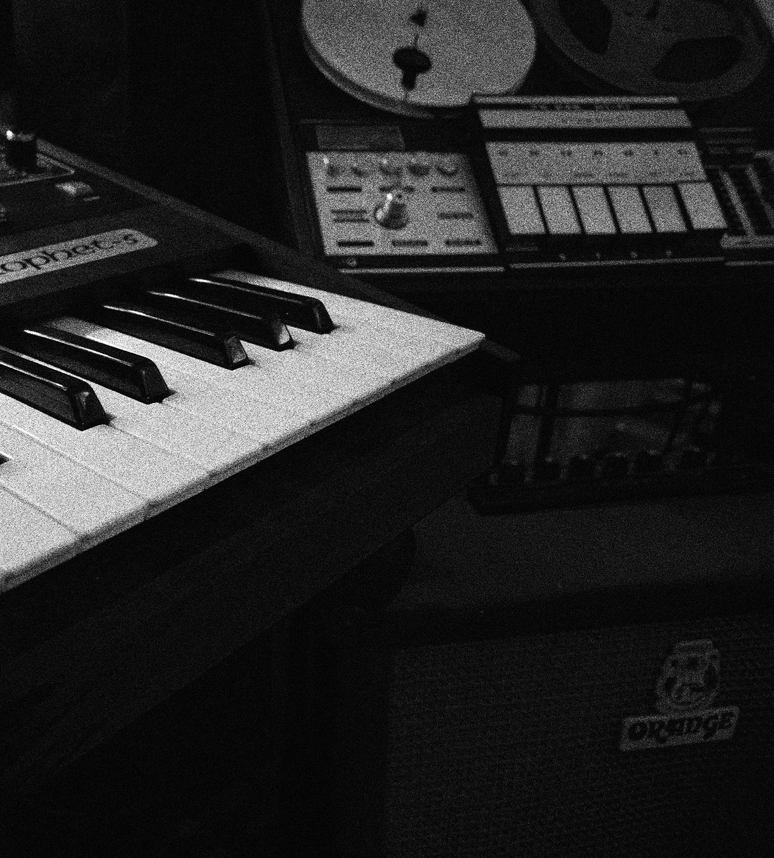 A Rhodes keyboard beside a reel-to-reel tape machine